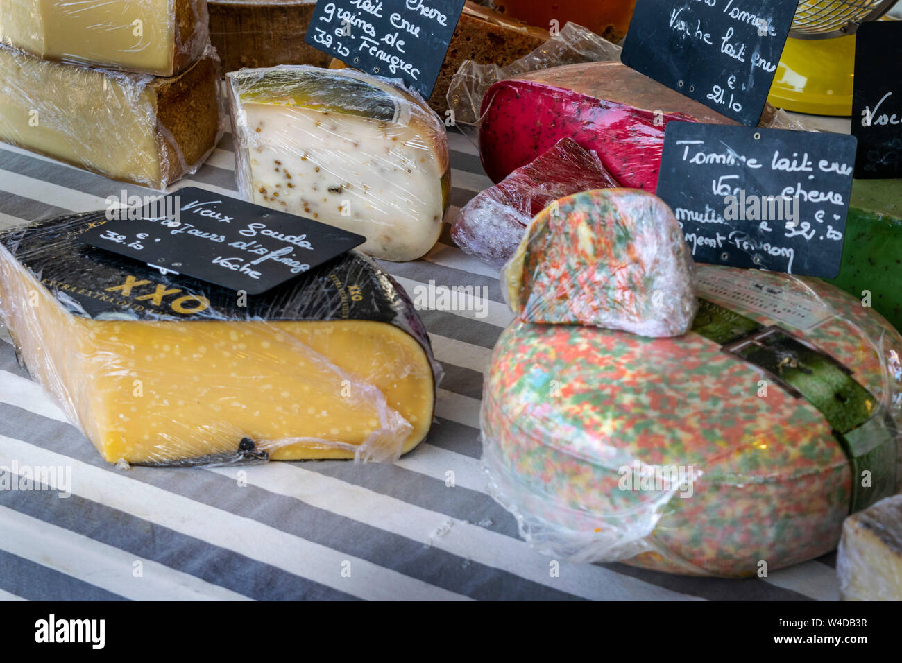 A colourful selection of cheeses on sale at a French market in Lavardac Stock Photo