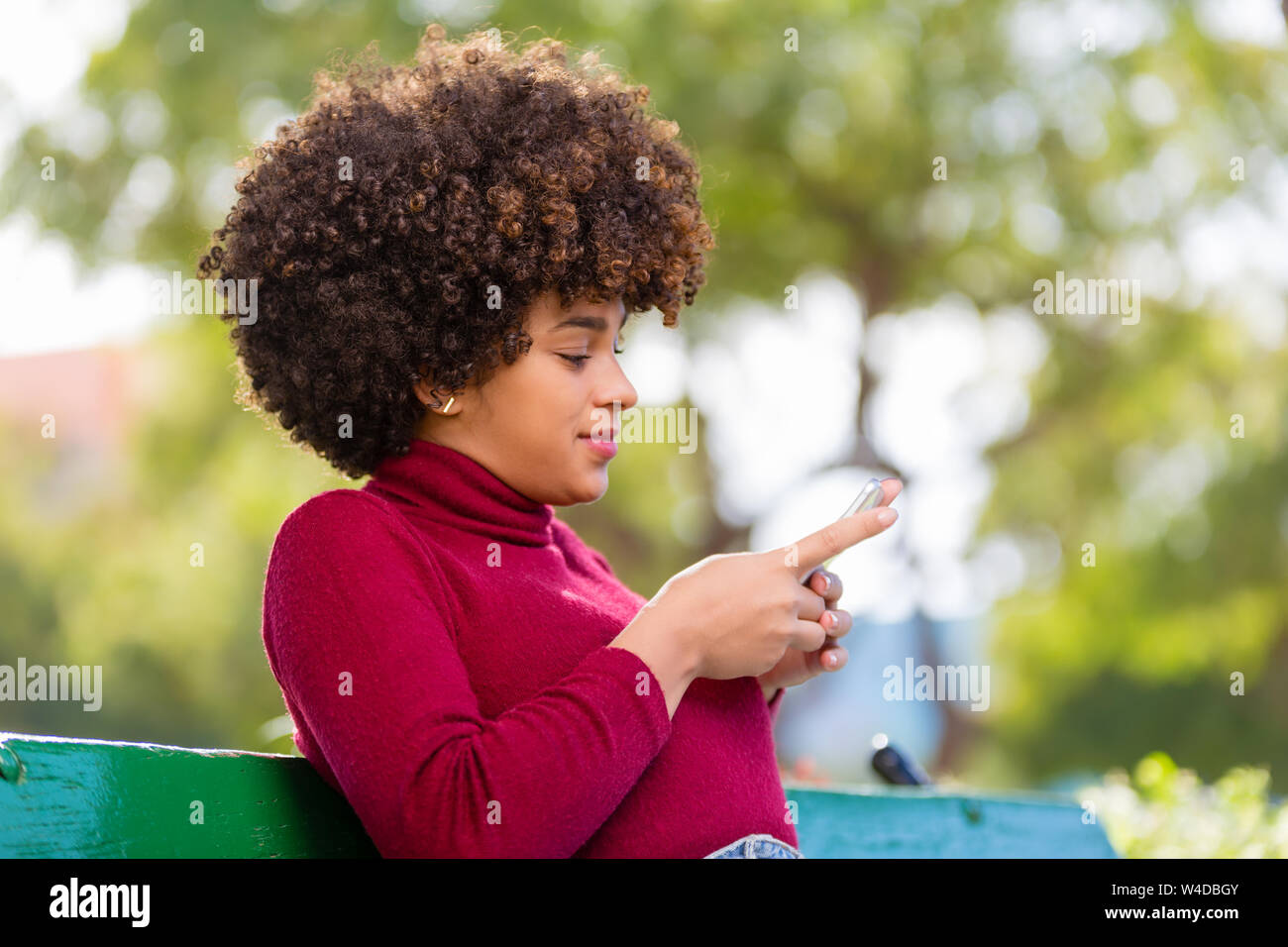 Outdoor portrait of a Young black African American young woman speaking ...