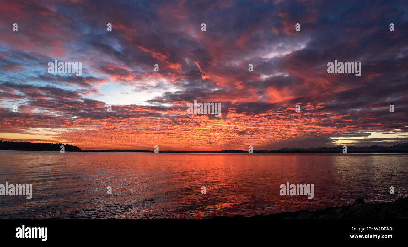 The sun sets over Elliott Bay in Seattle, Washington. Stock Photo