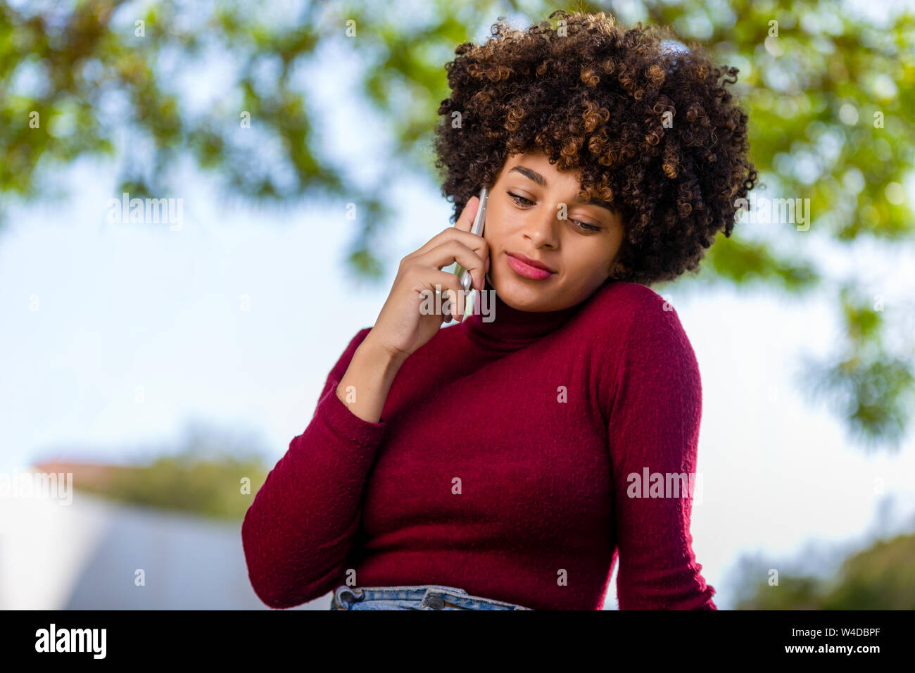 Outdoor portrait of a Young black African American young woman speaking ...