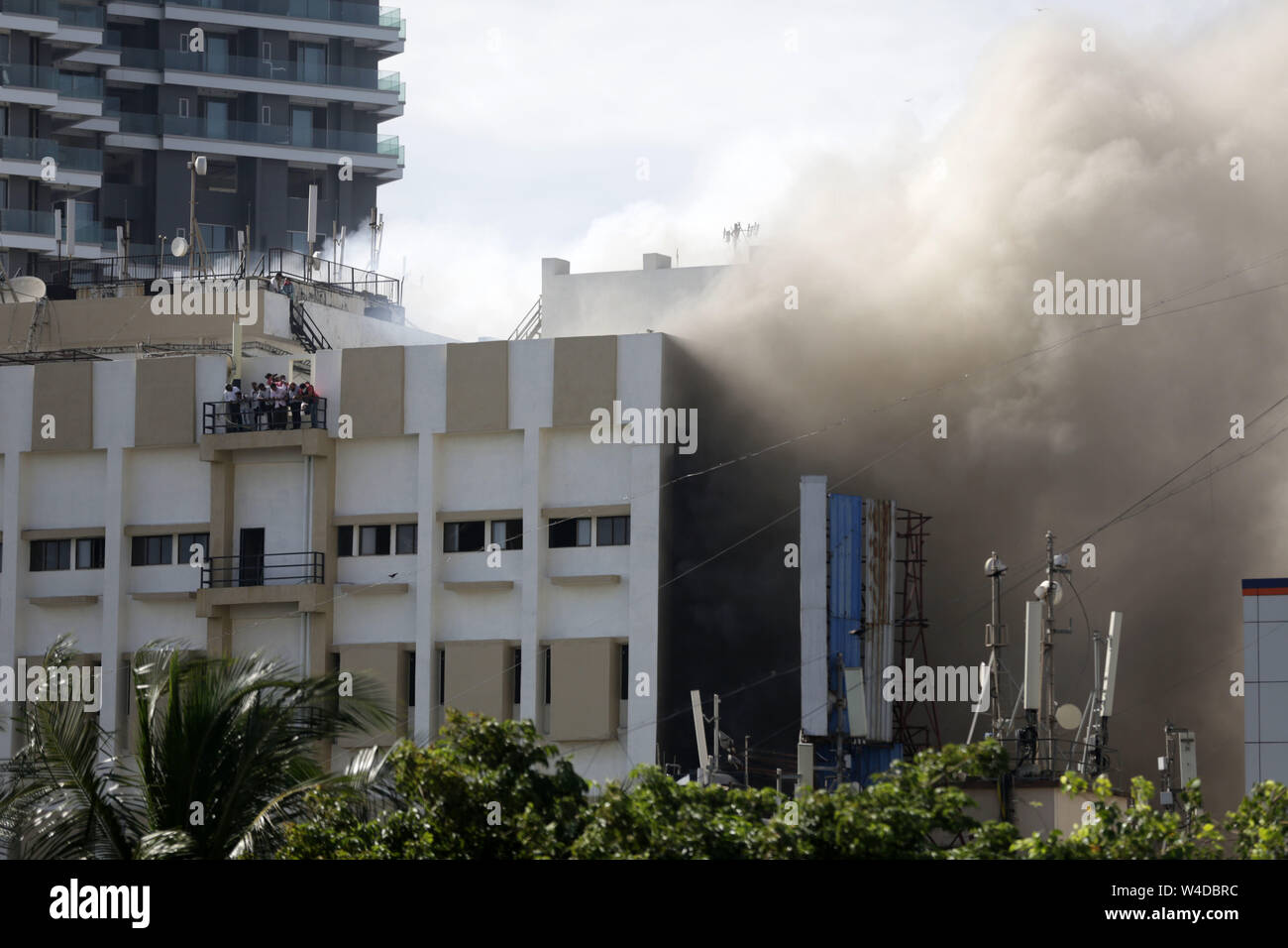 Mumbai, India. 22nd July, 2019. People wait for rescue on the balcony of Mahanagar Telephone Nigam Limited (MTNL) building after a fire broke out in Mumbai, India, July 22, 2019. (Str/Xinhua) Credit: Xinhua/Alamy Live News Stock Photo