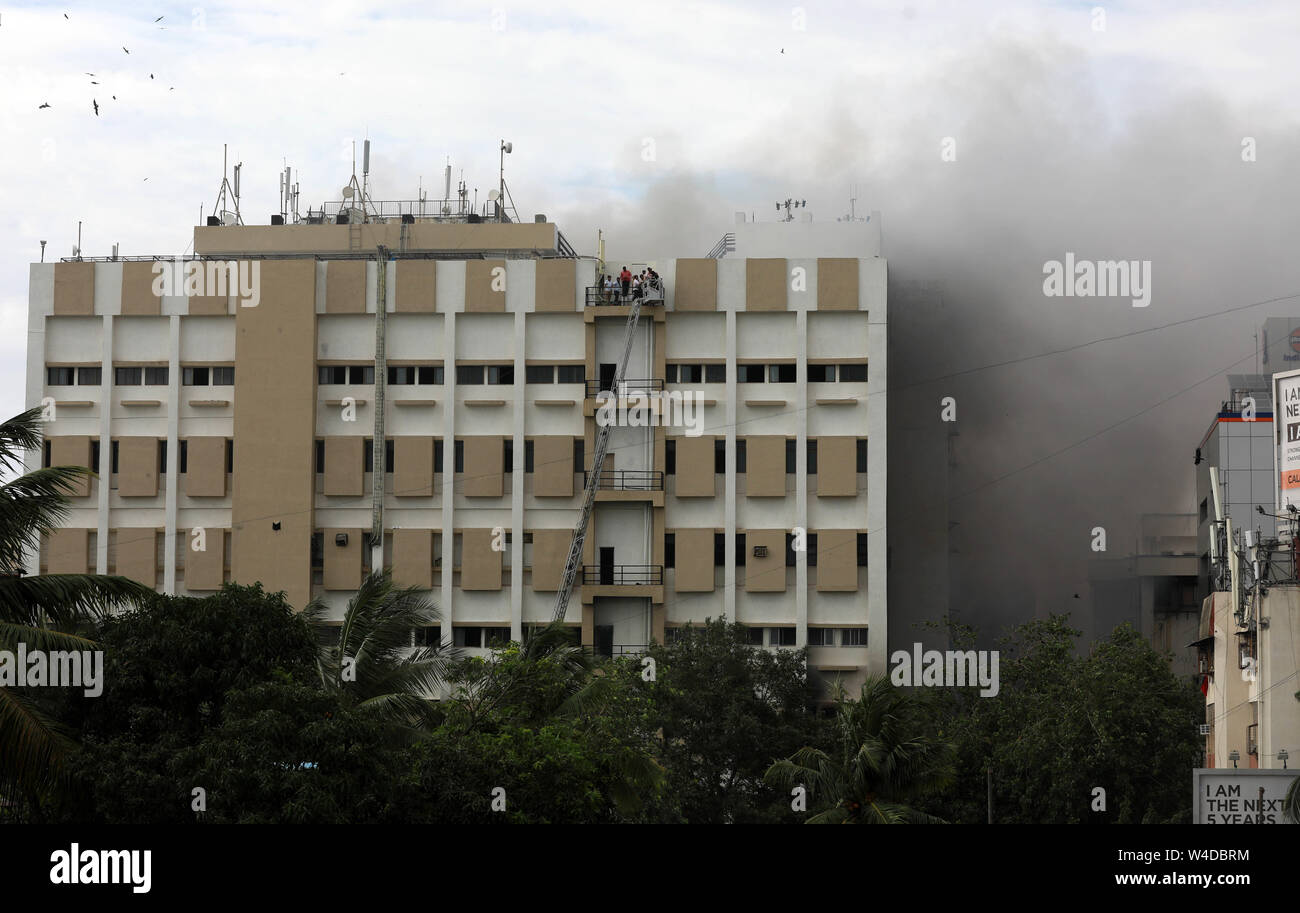 Mumbai, India. 22nd July, 2019. Indian firefighters rescue people from Mahanagar Telephone Nigam Limited (MTNL) building after a fire broke out in Mumbai, India, July 22, 2019. (Str/Xinhua) Credit: Xinhua/Alamy Live News Stock Photo