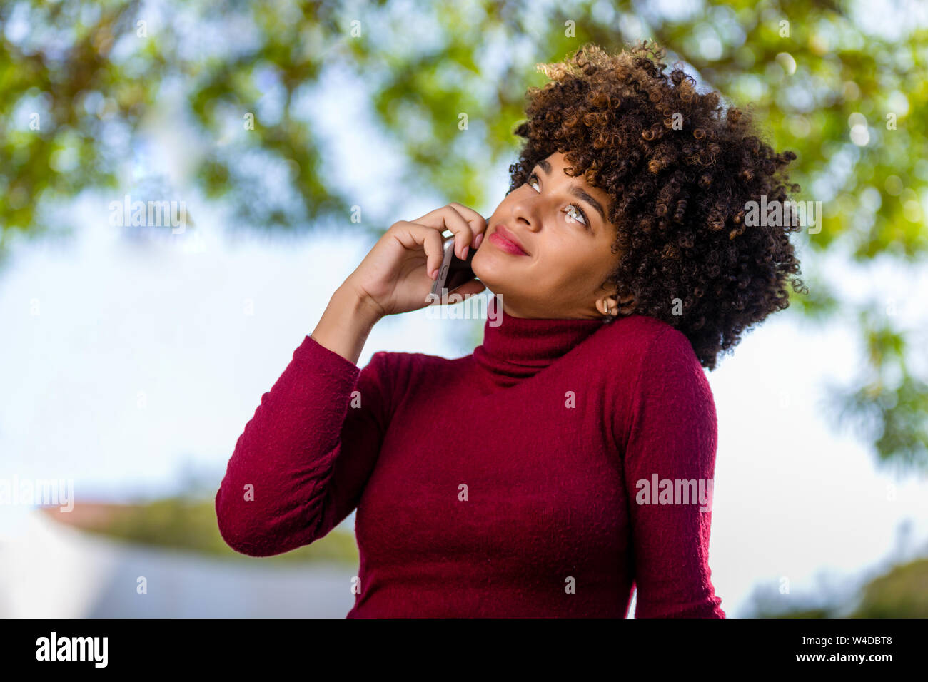 Outdoor portrait of a Young black African American young woman speaking ...