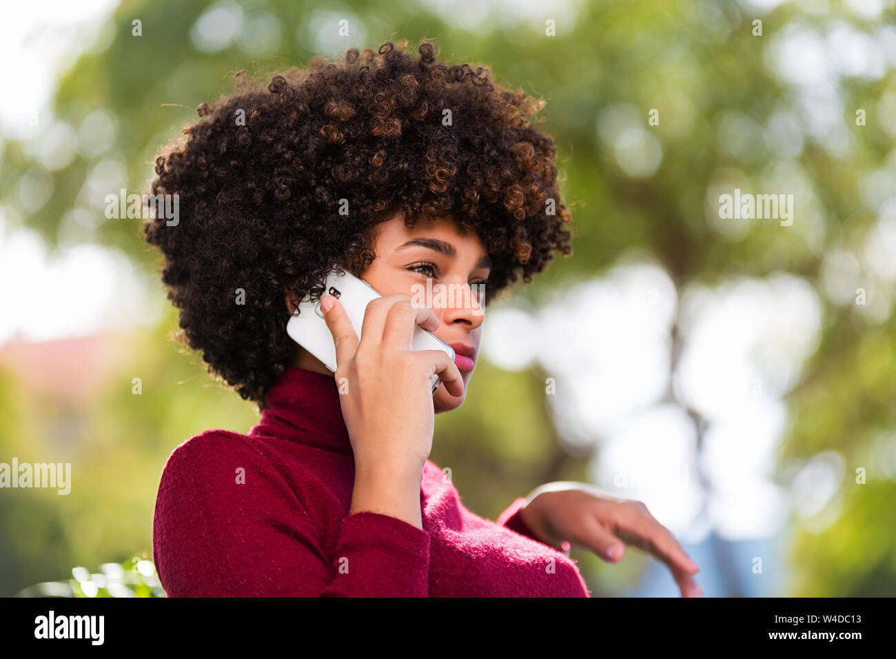 Outdoor portrait of a Young black African American young woman speaking ...