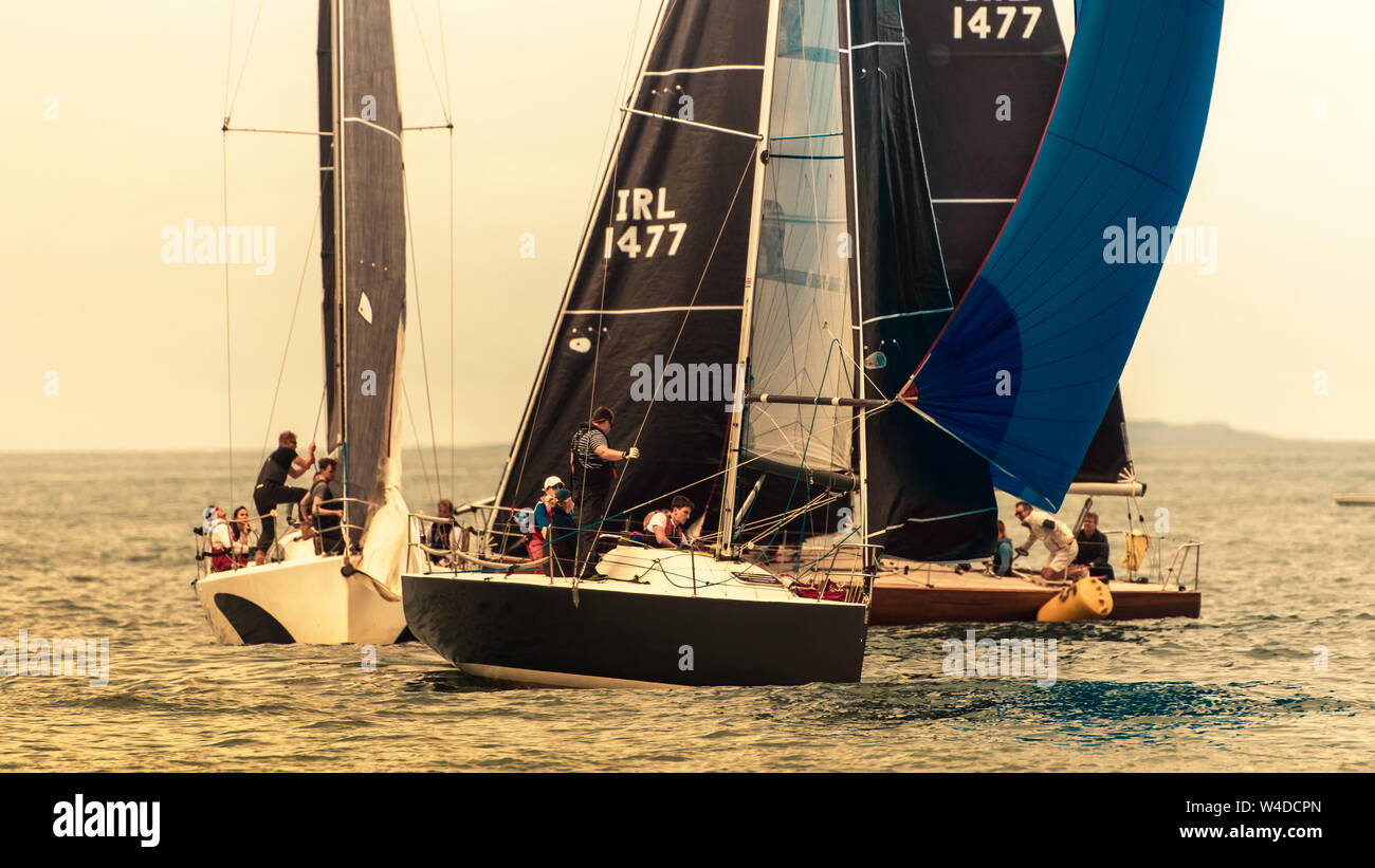 Sailing together. Rounding the buoy. Group of sailboats approached