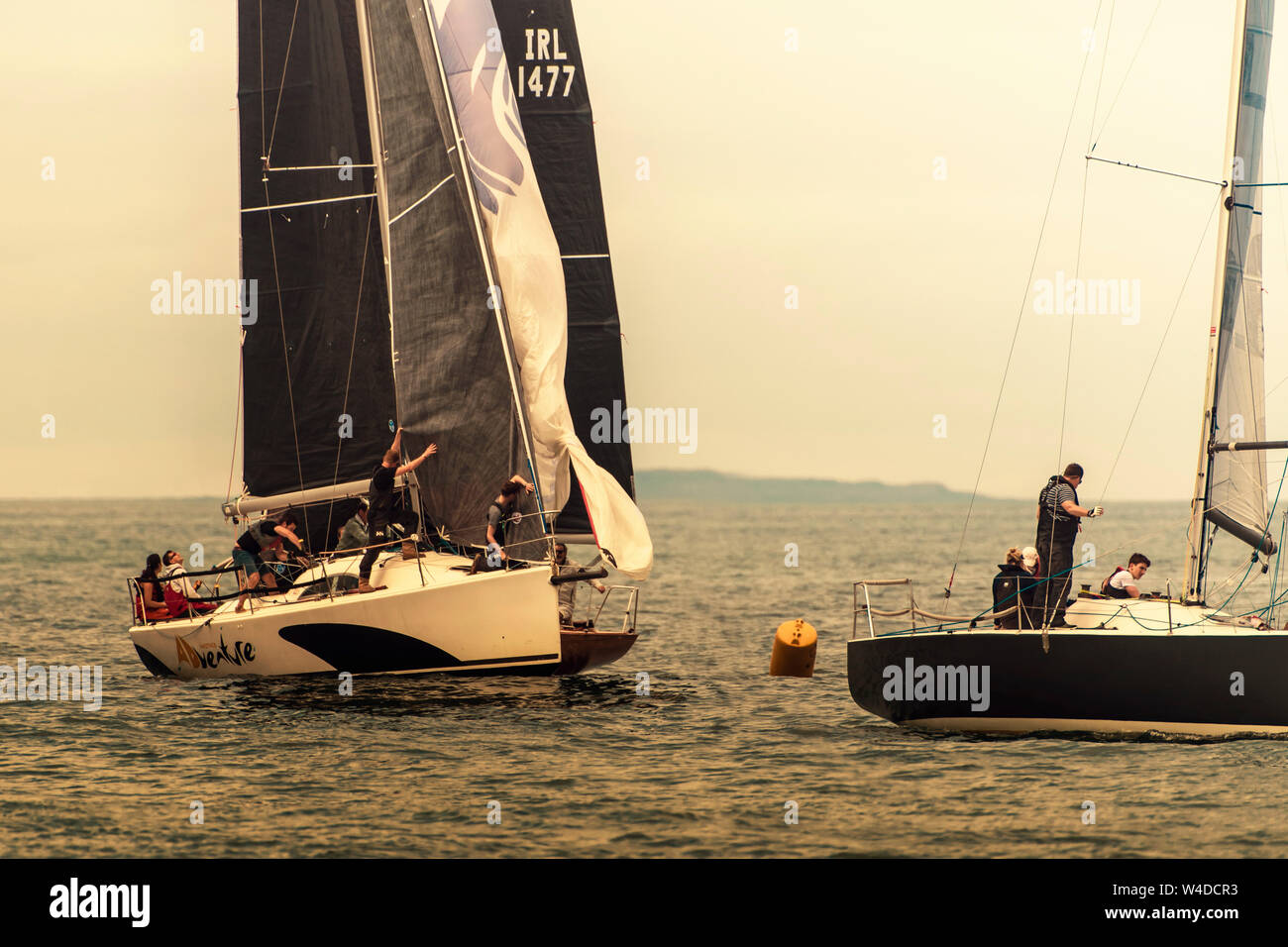 Sailing together. Rounding the buoy. Group of sailboats approached