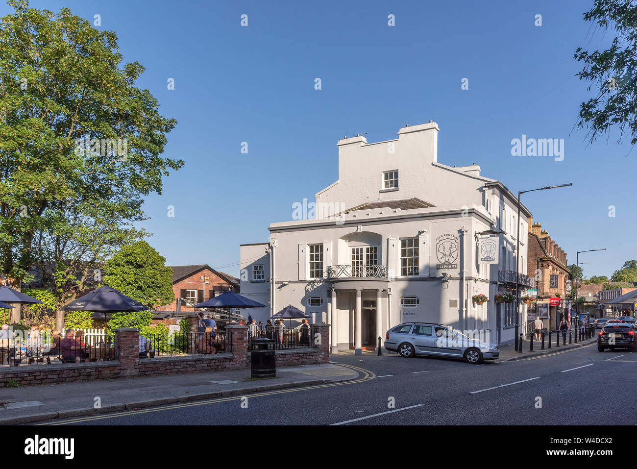 THe centre of Woolton village Liverpool on a summers evening. The pub