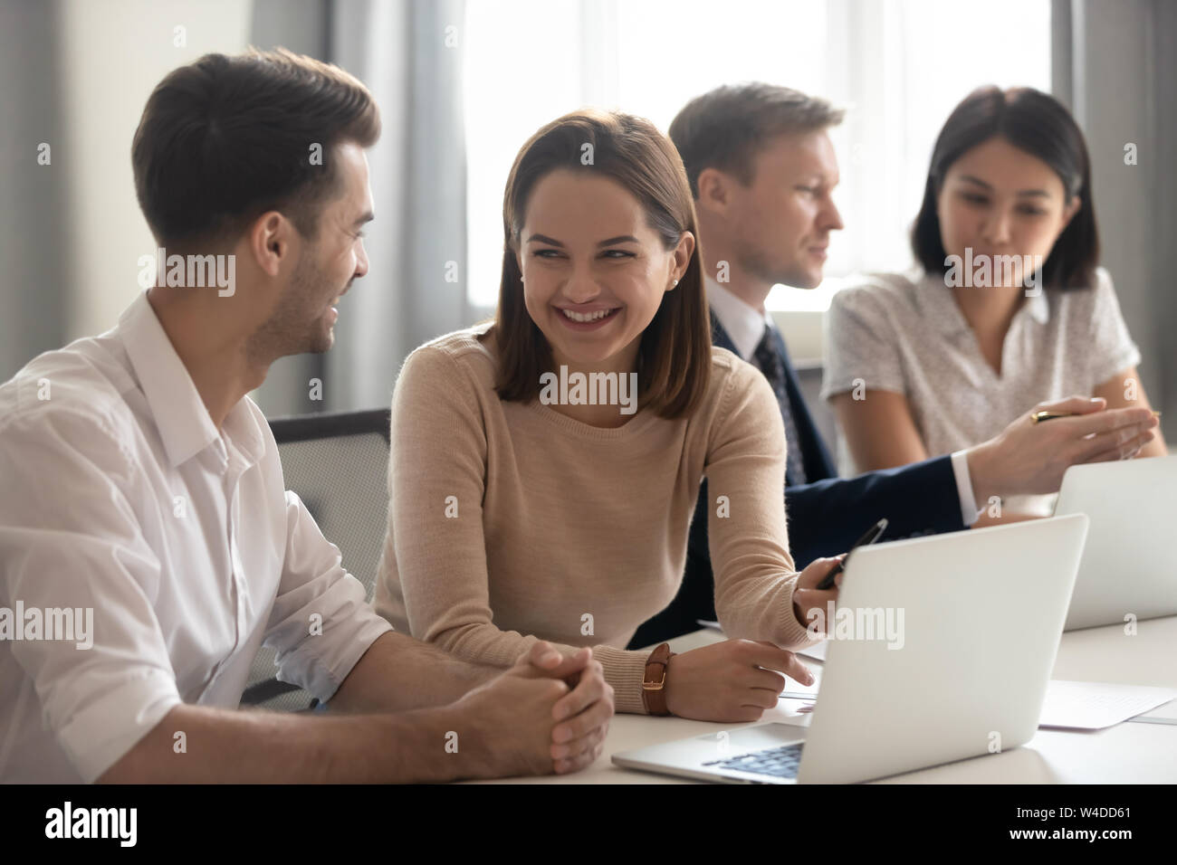 Cheerful colleagues business team having fun talking at work break Stock Photo