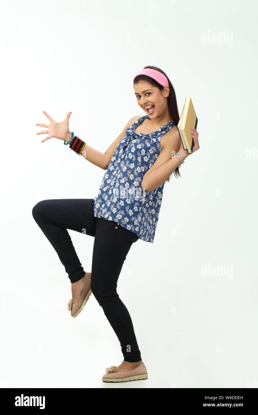 College girl holding a book and smiling Stock Photo - Alamy