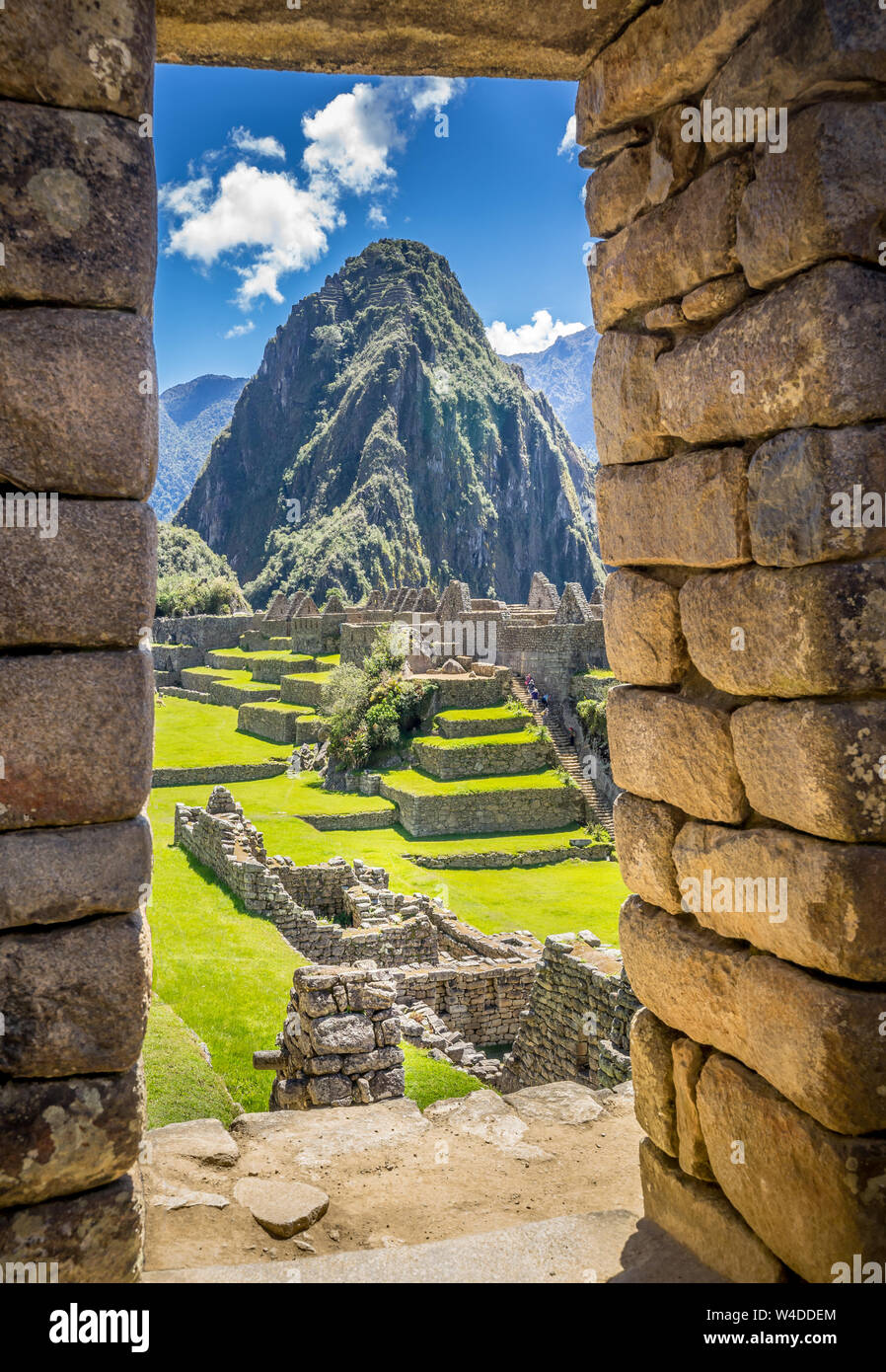 The Inca ruins of Machu Picchu, UNESCO World Heritage Site through the frame of stone wall Stock Photo