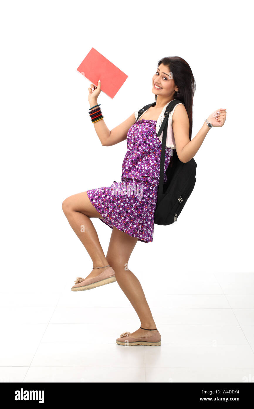 College girl holding book and smiling Stock Photo - Alamy