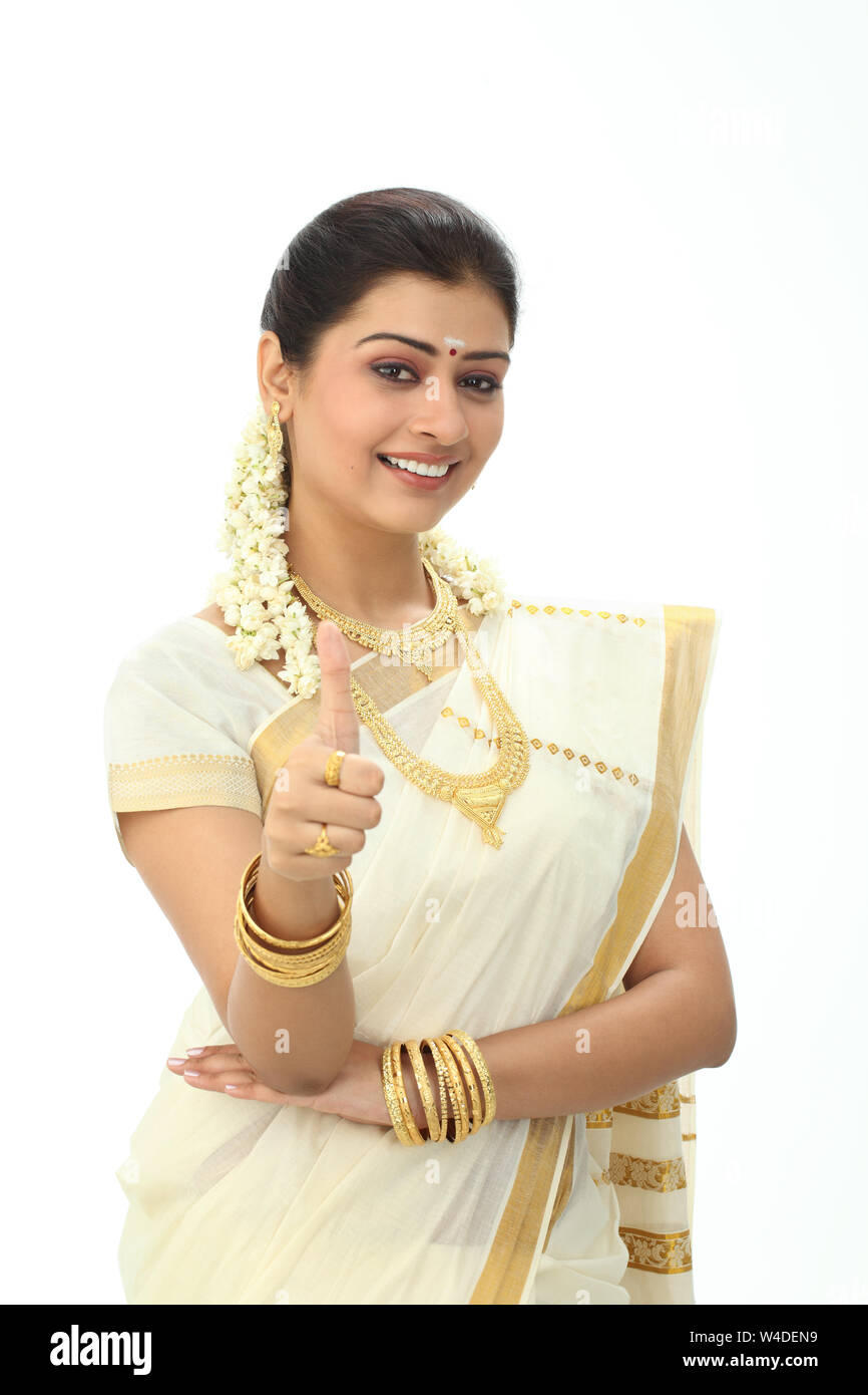 South Indian woman showing thumbs up sign and smiling Stock Photo - Alamy