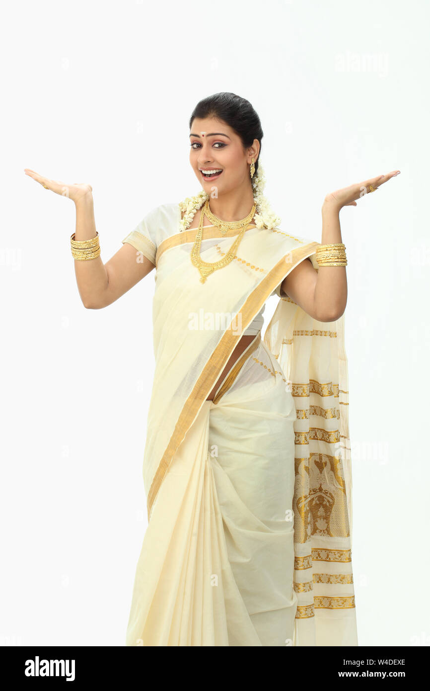 South Indian woman smiling with arm outstretched Stock Photo - Alamy