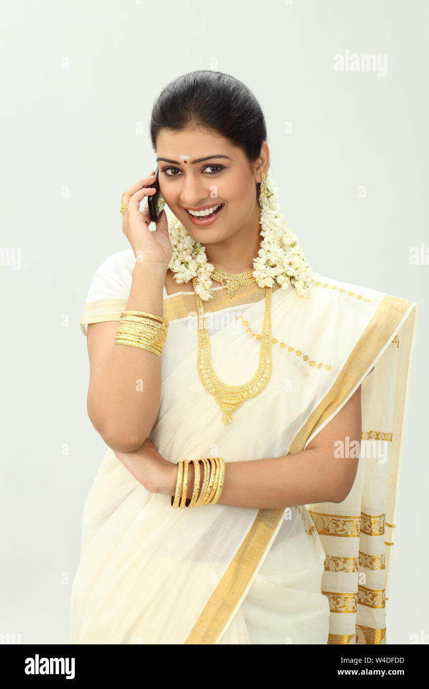 South Indian woman talking on mobile phone and smiling Stock Photo - Alamy