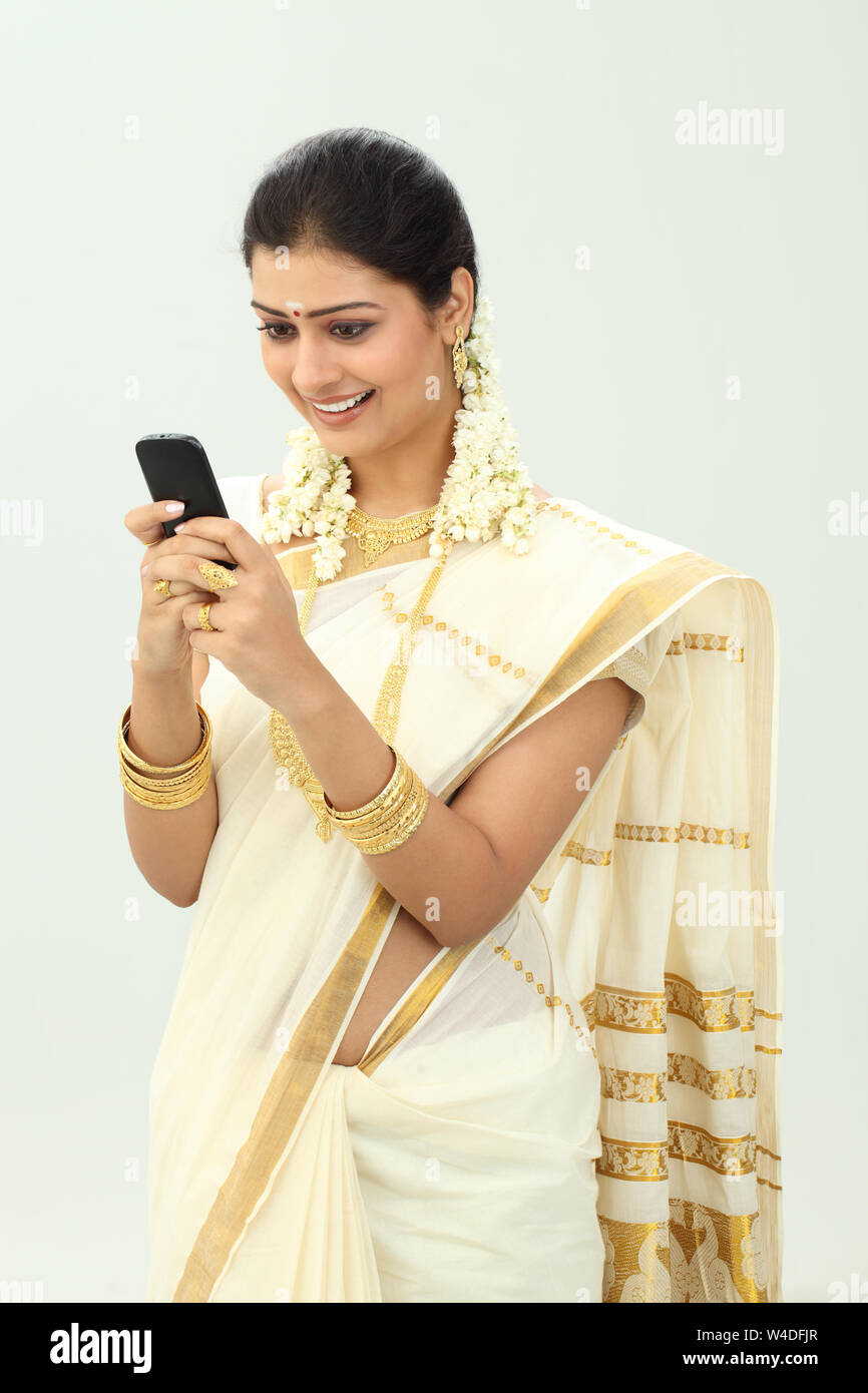 South Indian woman text messaging and smiling Stock Photo - Alamy