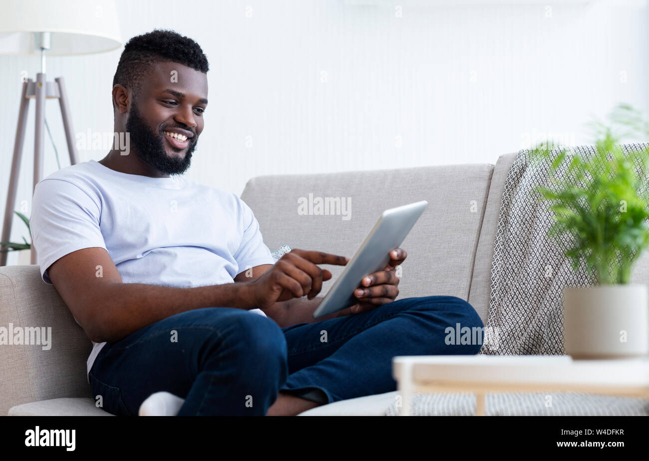 Young african american man using his digital tablet Stock Photo