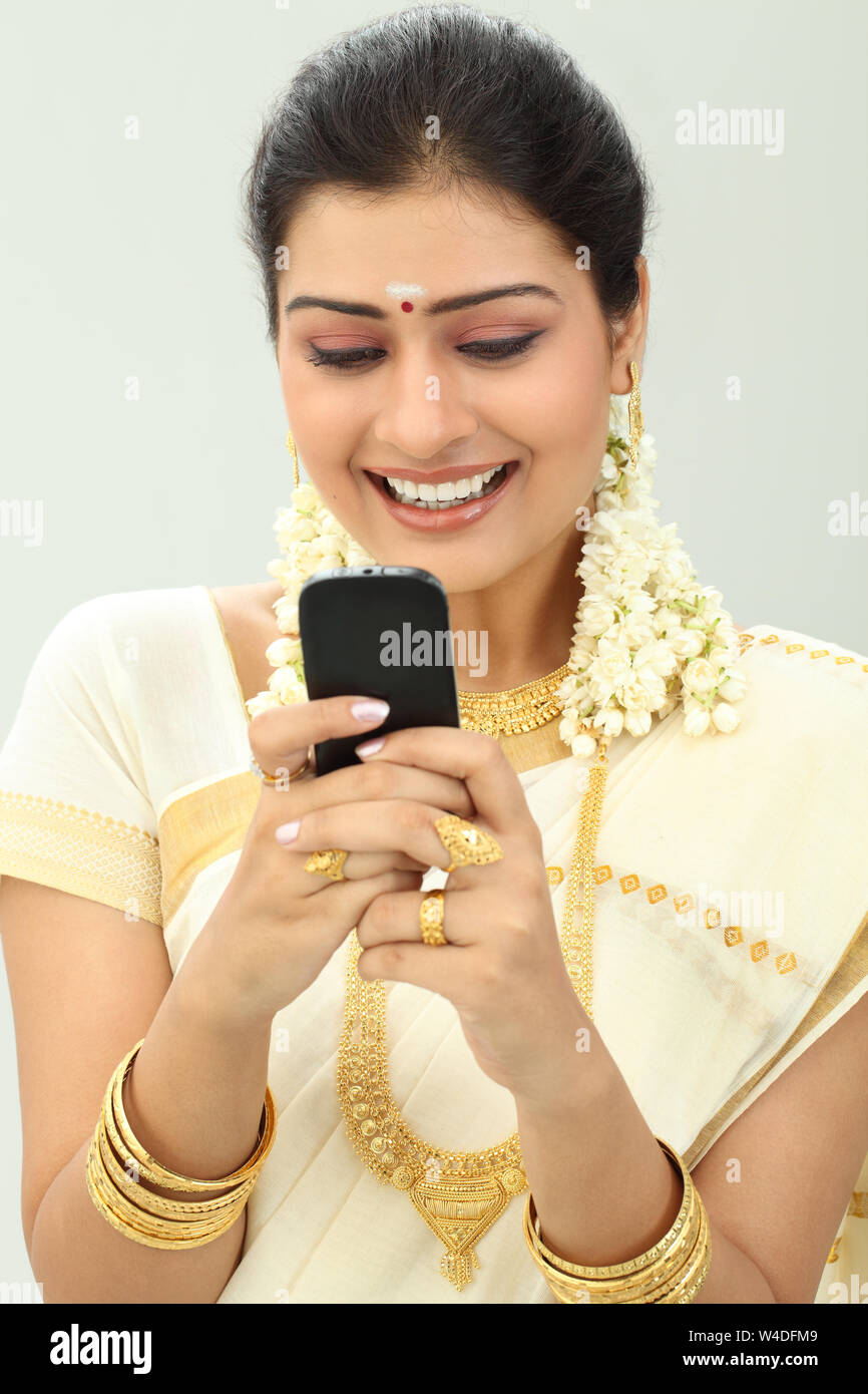 South Indian woman text messaging and smiling Stock Photo - Alamy