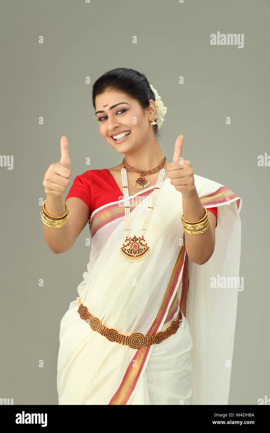 South Indian woman showing thumbs up sign and smiling Stock Photo - Alamy