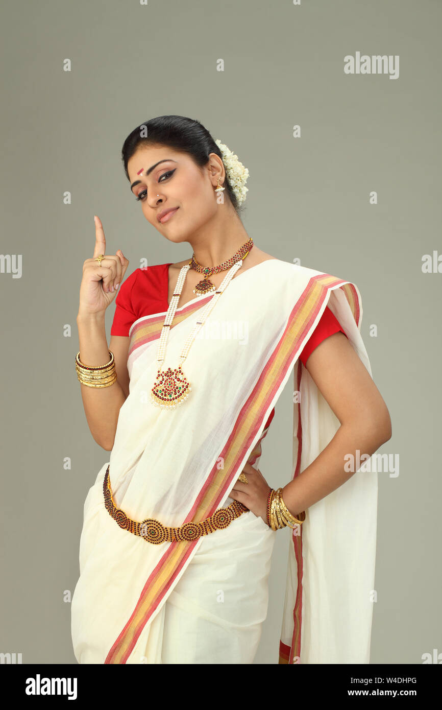 South Indian woman standing and pointing upward Stock Photo - Alamy