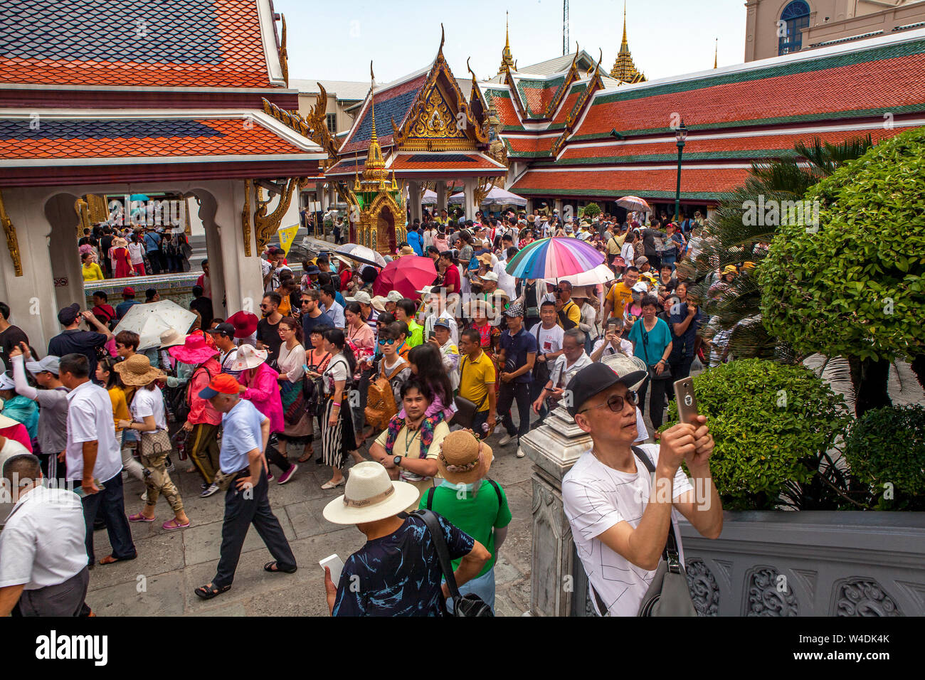 Huge crowds of tourist swarm the Grand Palace in Bangkok, Thailand. Phra Thinang Sanam Chan building is center background. Stock Photo
