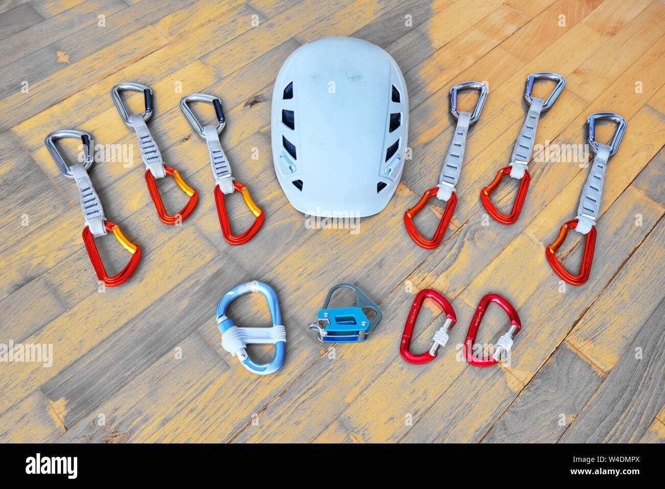 Top down view of essential sport climbing gear helmet, belay plate