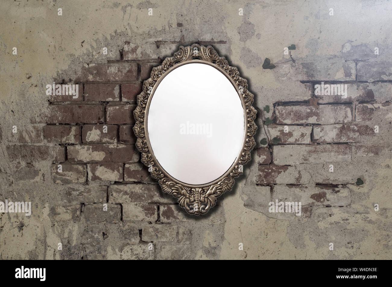 Vintage antique mirror on old brick wall background texture Stock Photo