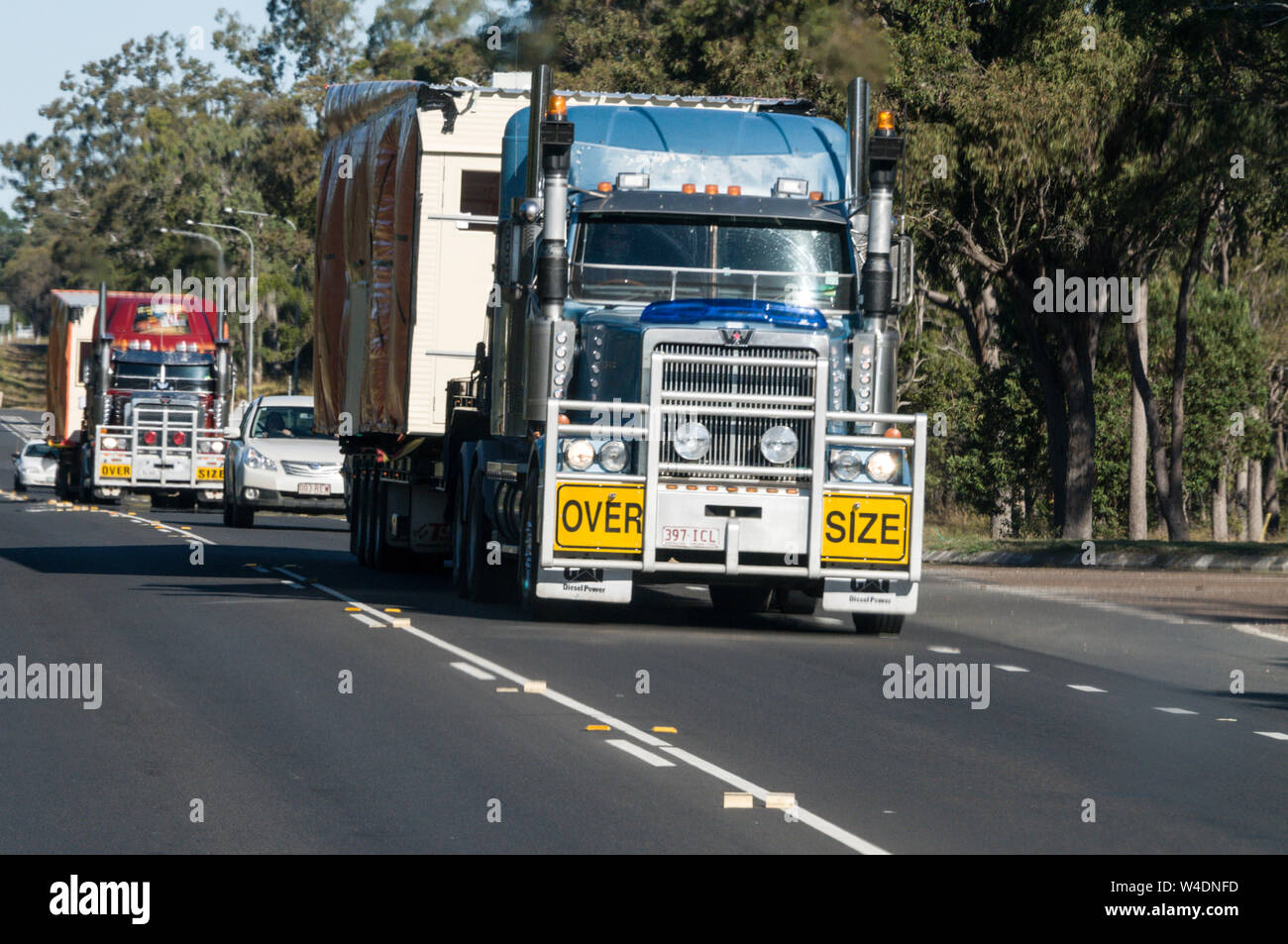 Oversize road trains transporting heavy loads on the Bruce Highway to