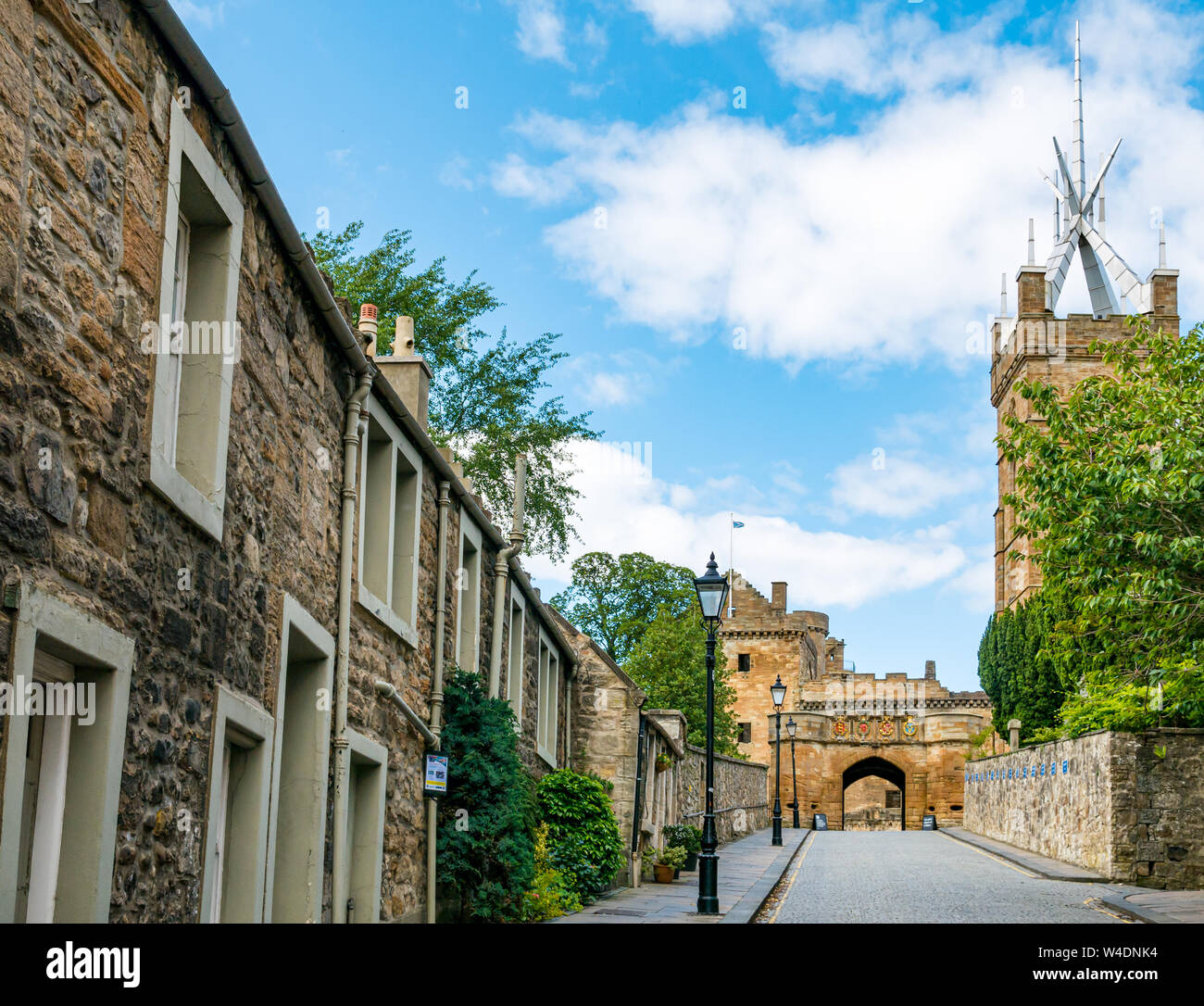 Cobbled narrow lane entrance, Linlithgow Palace, with St Michael's Parish Church, West Lothian, Scotland, UK Stock Photo