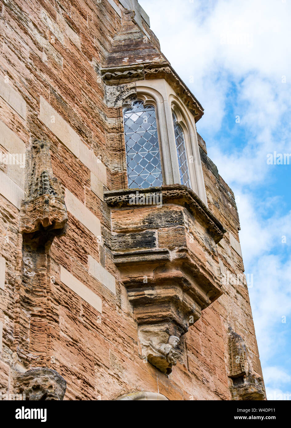 Oriel window on worn old sandstone wall, St Michael's Parish Church, Linlithgow, Scotland, UK Stock Photo