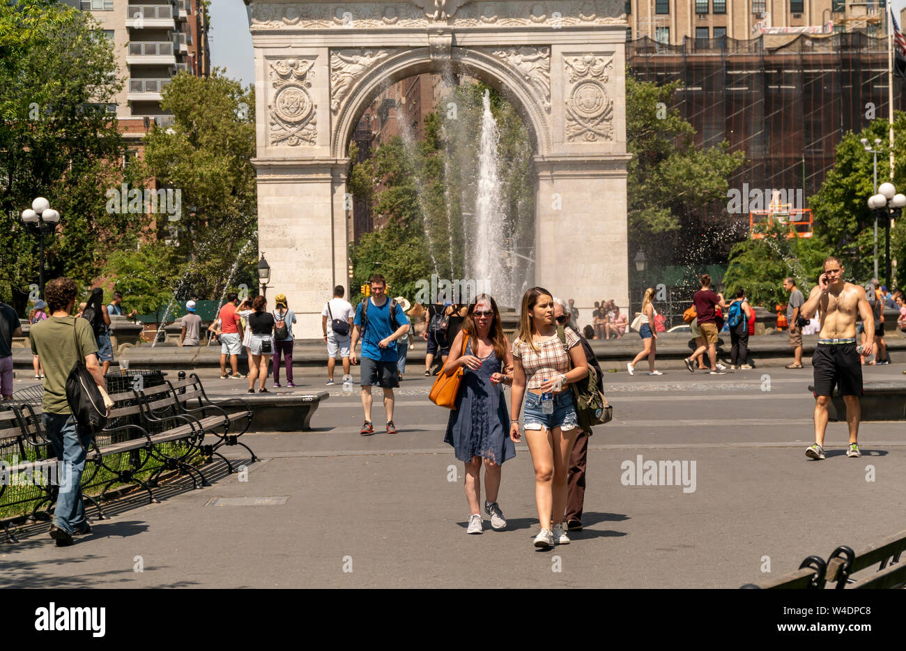 New Yorkers and visitors in Washington Square Park in Greenwich Village in New York on Saturday, July 20, 2019. An excessive heat warning is in effect in New York from noon Friday until 8PM Sunday as the oppressive combination of heat and humidity will make it feel like 105 degrees F. (© Richard B. Levine) Stock Photo