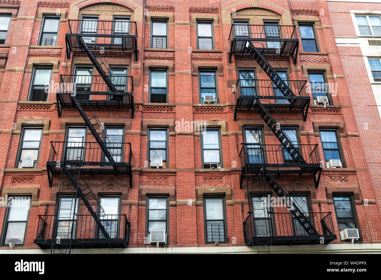 Old typical apartment buildings with its fire escape in the Harlem