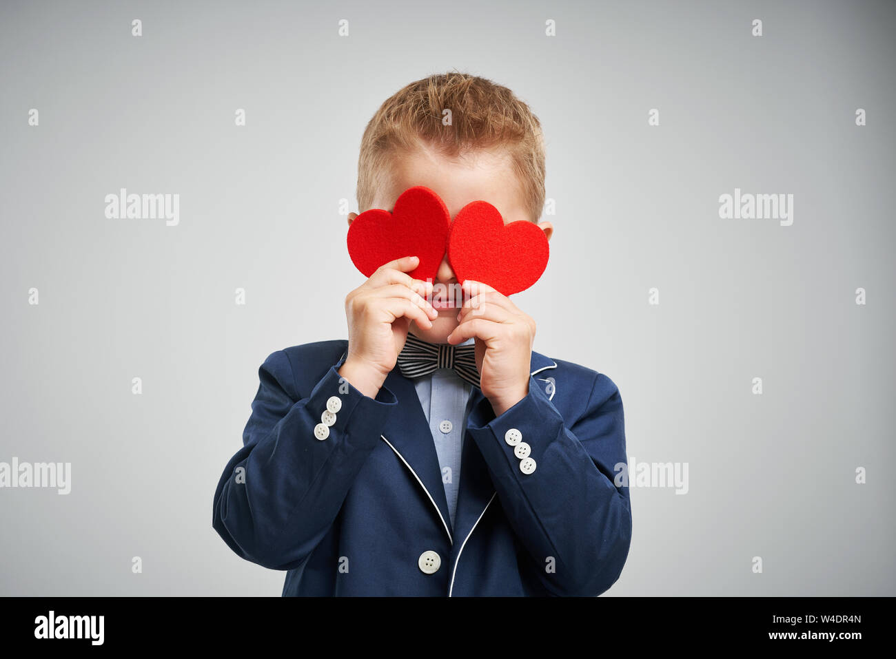 Portrait of happy cute little kid holding red heart Stock Photo - Alamy