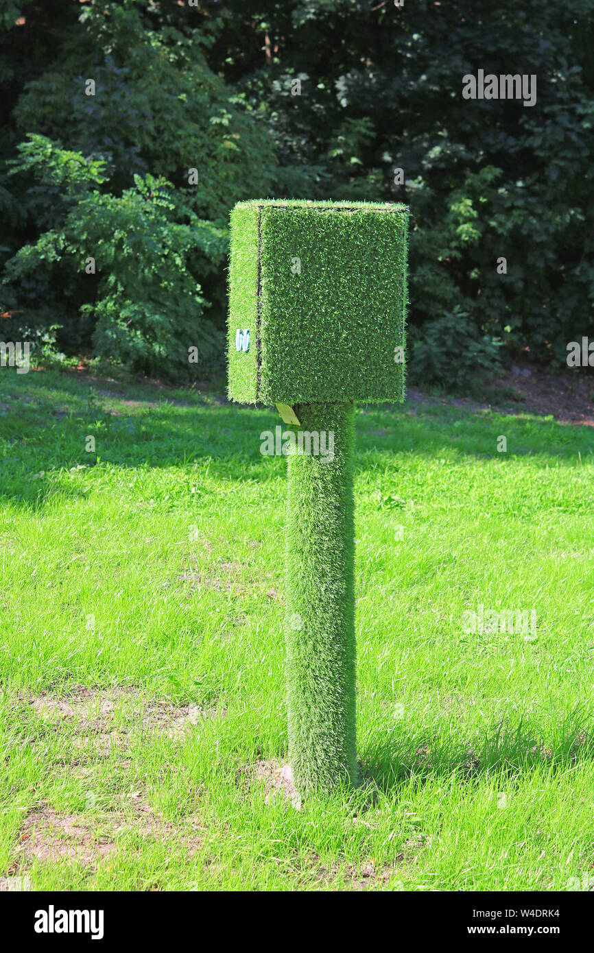 Control point disguised by artificial grass on the background of natural grass Stock Photo