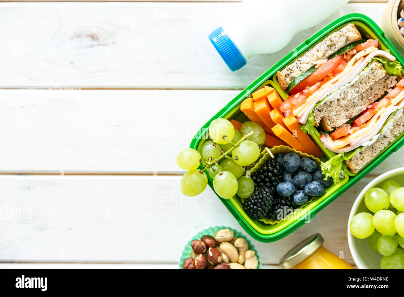 Back to school concept lunch box with juice, apple and banana Stock