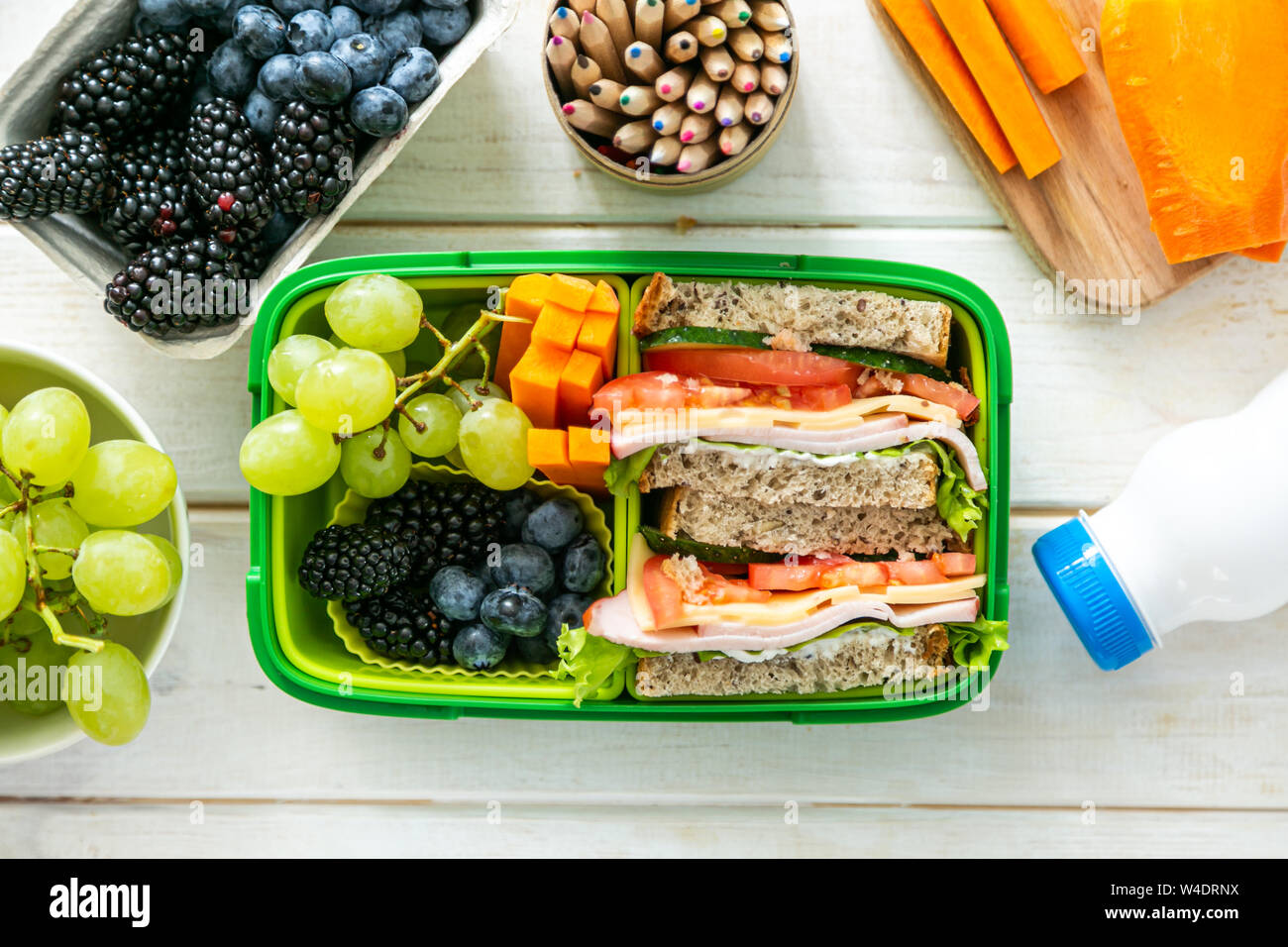 Back to school concept lunch box with juice, apple and banana Stock
