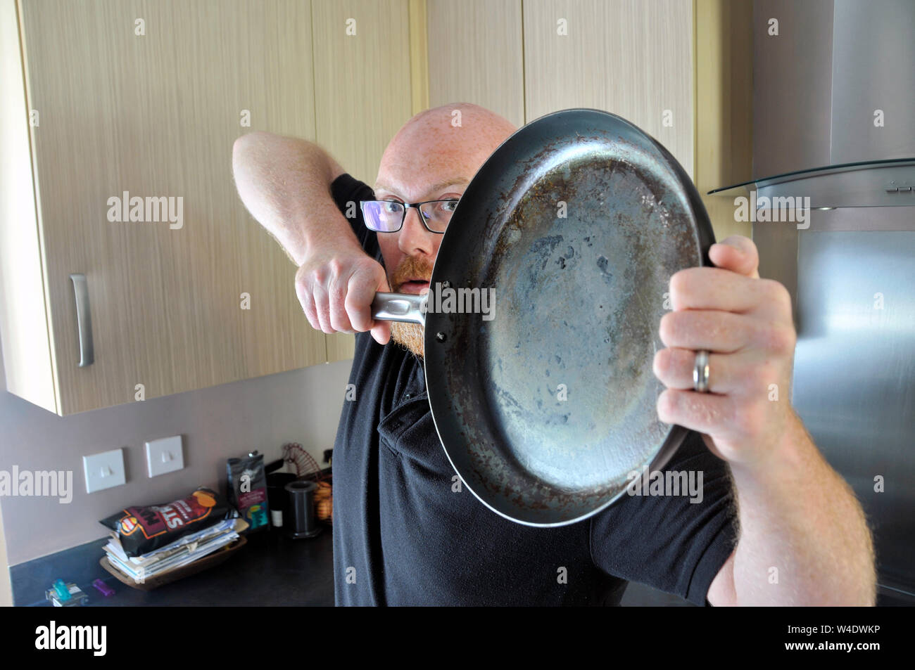 man with cast iron pan Stock Photo