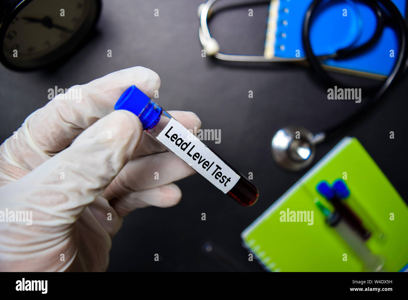 Lead Level Test text with blood sample. Top view isolated on black