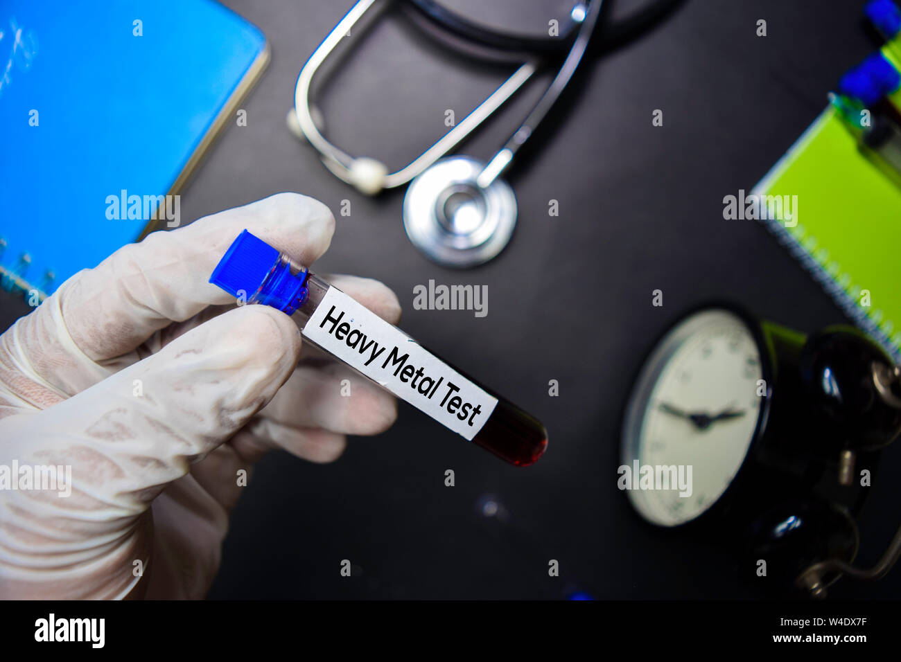 Heavy Metal Test text with blood sample. Top view isolated on black