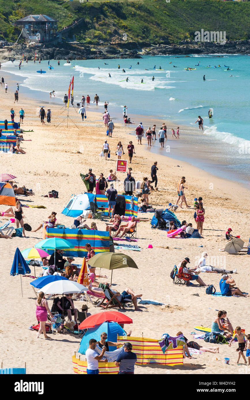 Holidaymakers enjoying a staycation holiday at Fistral Beach in Newquay in Cornwall. Stock Photo