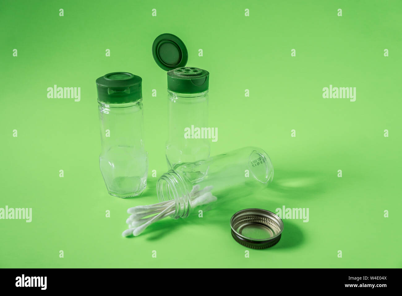 https://c8.alamy.com/comp/W4E04X/3-glass-spice-jars-on-lime-green-background-with-blank-empty-room-space-for-text-or-copy-three-kitchen-bottles-recycled-and-reused-to-store-cotton-sw-W4E04X.jpg