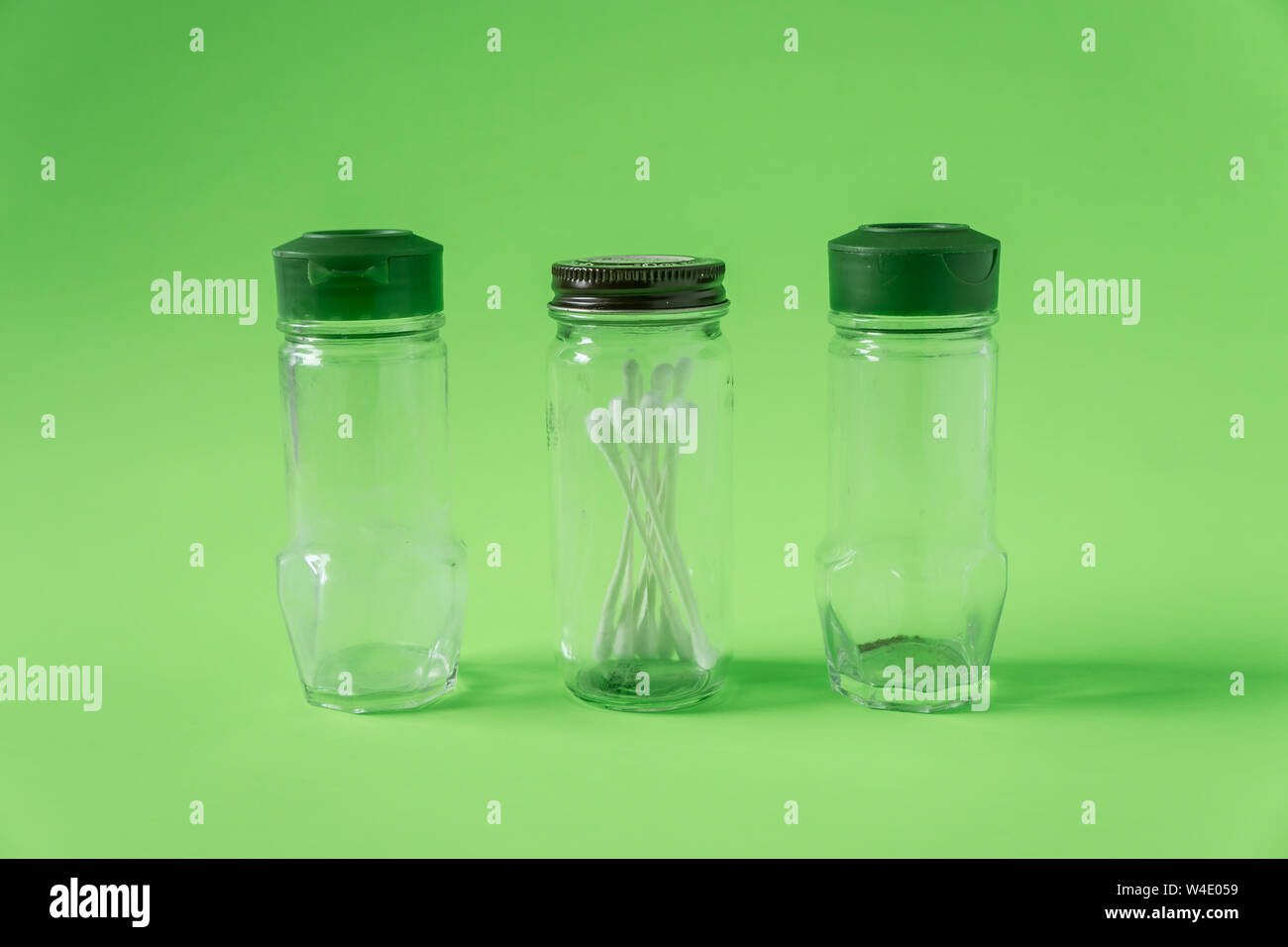 https://c8.alamy.com/comp/W4E059/3-glass-spice-jars-on-lime-green-background-with-blank-empty-room-space-for-text-or-copy-three-kitchen-bottles-recycled-and-reused-to-store-cotton-sw-W4E059.jpg