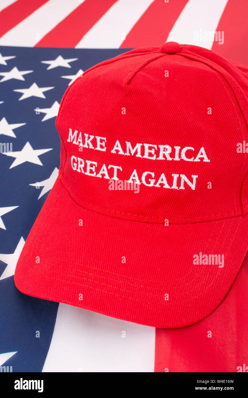 Red Donald Trump MAGA cap and U.S Stars & Stripes flag. Metaphor Maga hats, Trump supporters, Trump presidency, 2024 US election, Trump America first Stock Photo
