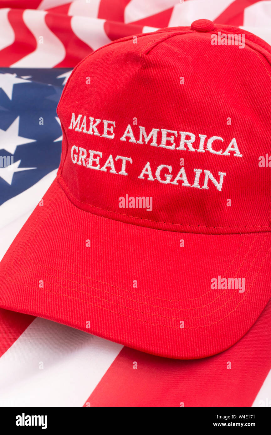 Red Donald Trump MAGA cap and U.S Stars & Stripes flag. Metaphor Maga hats, Trump supporters, Trump presidency, 2024 US election, Trump America first Stock Photo