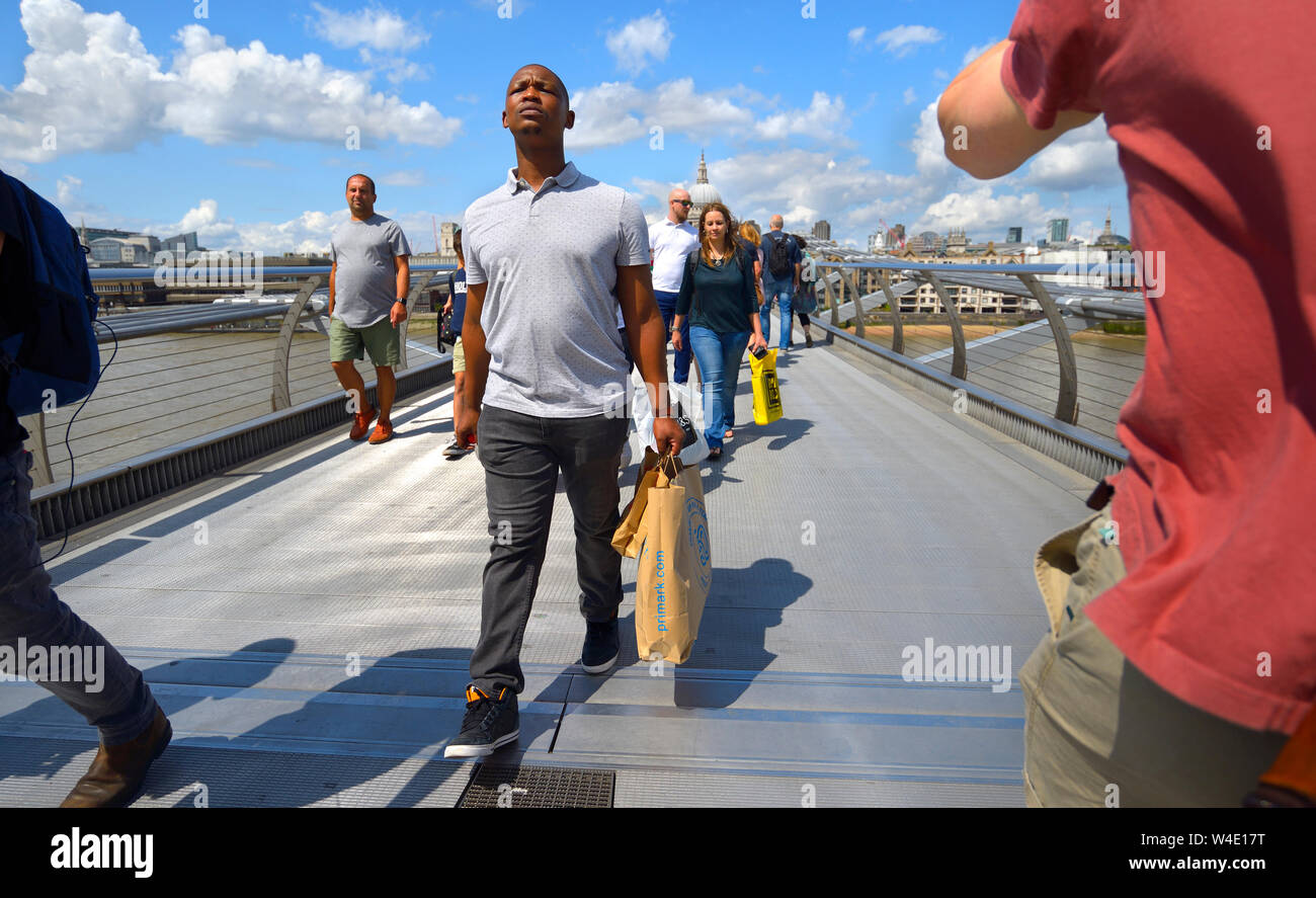 London, England, UK. Tourists crossing the Millennium Bridge Stock Photo