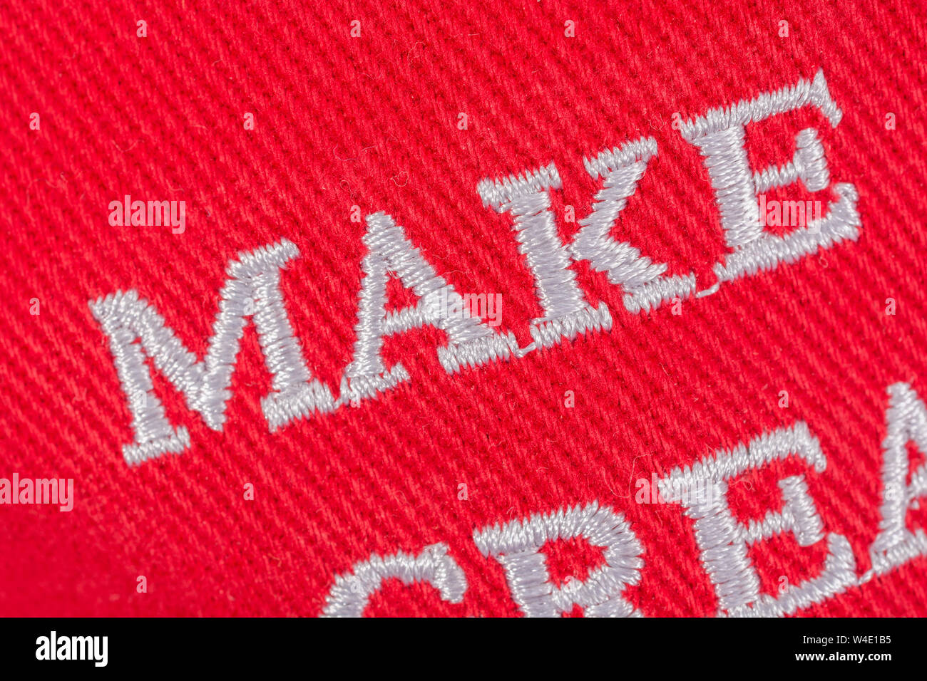 Macro close-up Red Trump MAGA cap focussing on 'Make'. Metaphor Maga hats, Trump supporters, Trump presidency 2024 U.S. elections, Trump America first Stock Photo