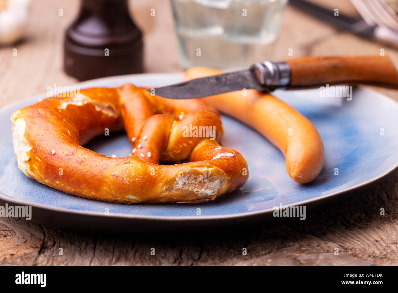 pretzel with frankfurt sausage on a plate Stock Photo