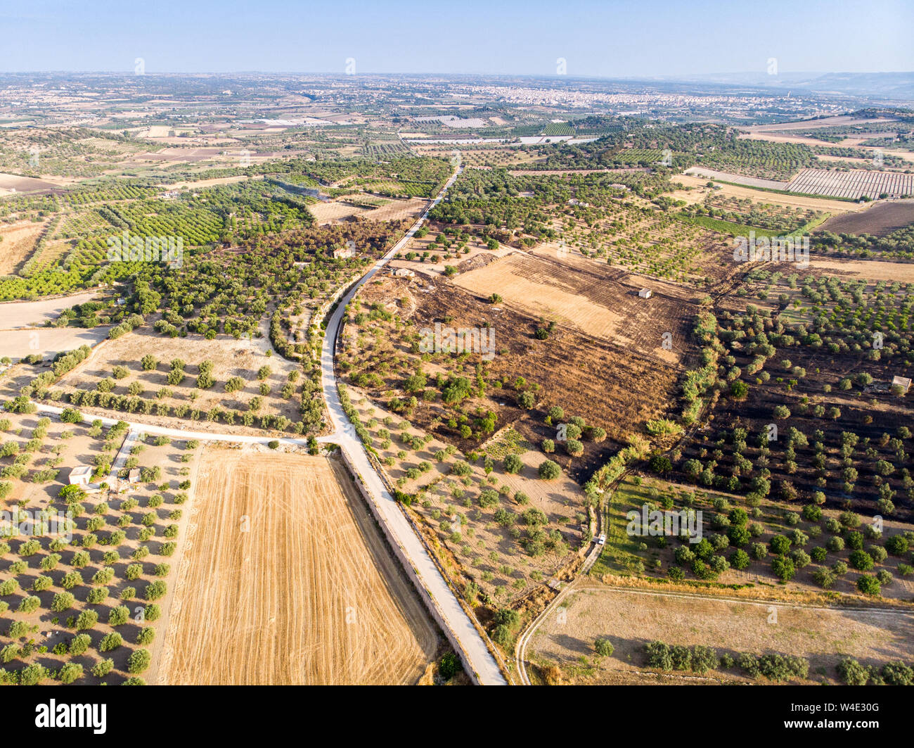 Aerial view of a rural field in the morning The shot is taken in a ...