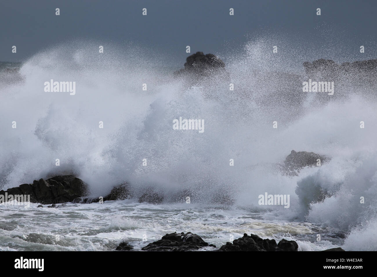 Big Stormy Waves Breaking In The Middle Of Cliffs And Rocks Big Stormy Waves Breaking In The Middle Of Cliffs And Rocks