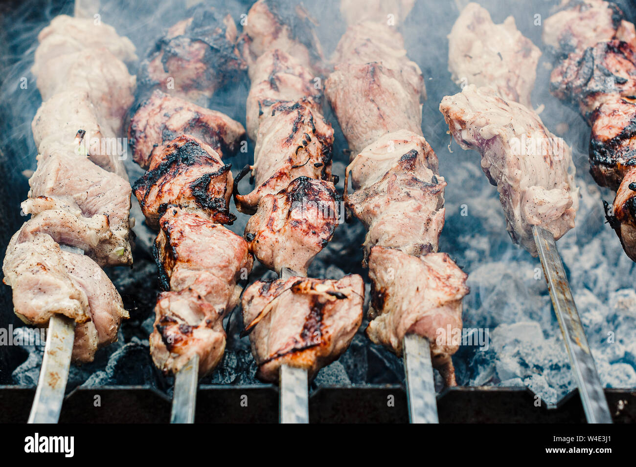 Shish kebab of meat skewered on a grill close-up outdoors Stock Photo -  Alamy