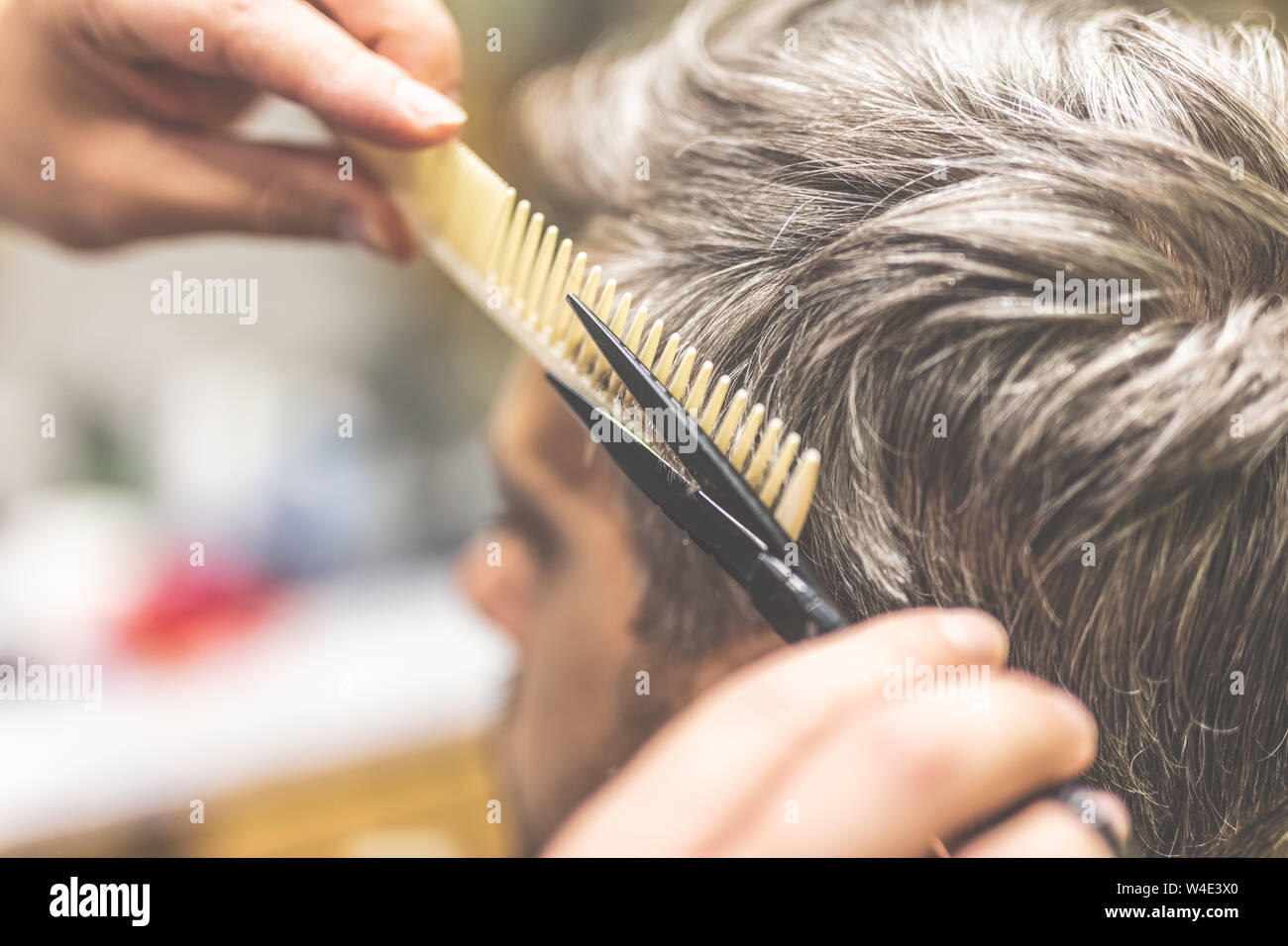 Close up of hairdresser styling man hair. Stock Photo